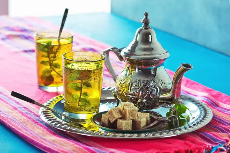 hot-moroccan-mint-green-tea-two-decorative-glasses-filled-metal-tray-matching-teapot-plate-brown-sugarcubes-66087770